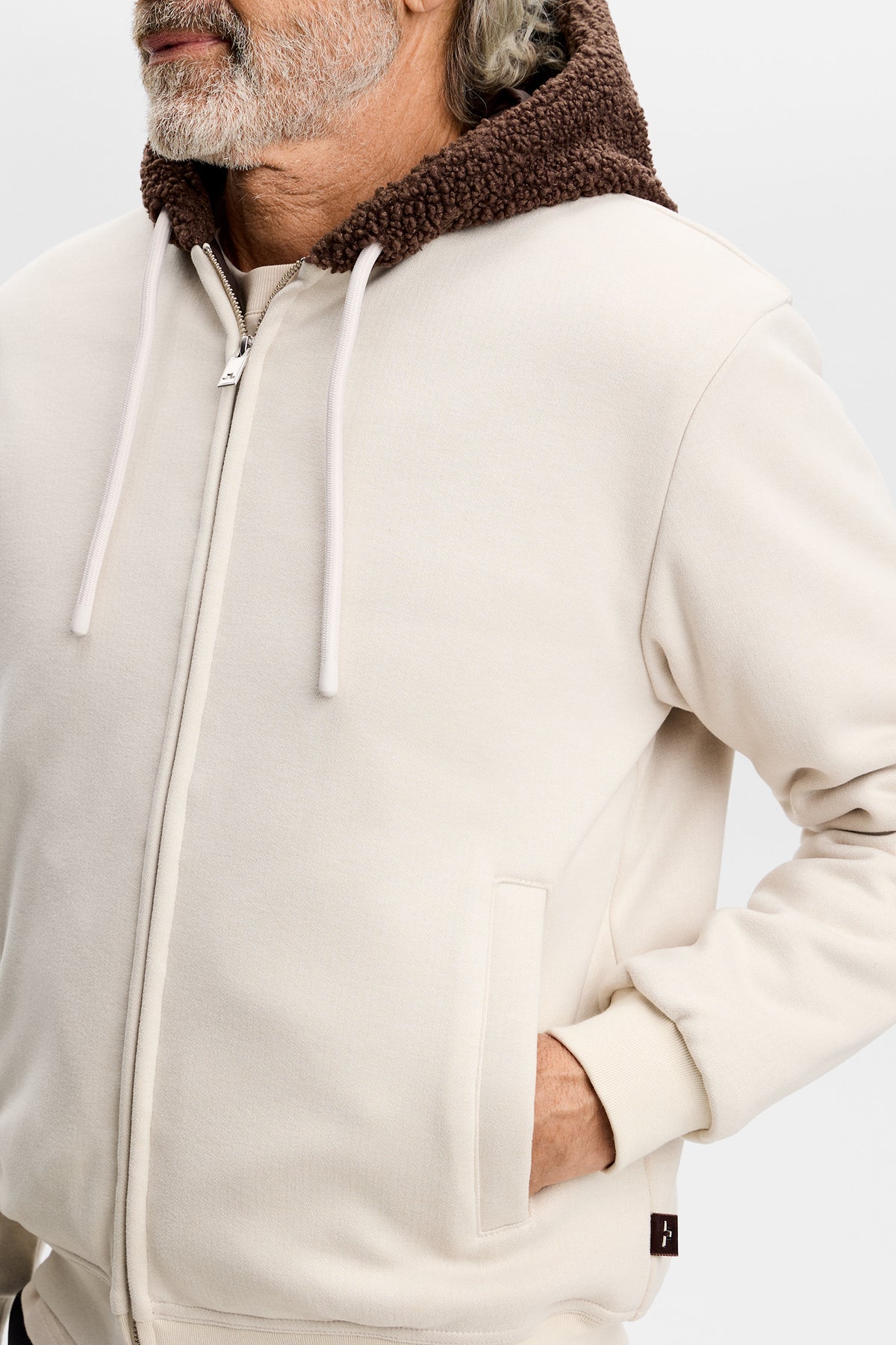 Close-up of the Henry Bonded Hoodie in Moonbeam, featuring a zip front, drawstrings, and fleece-lined hood.