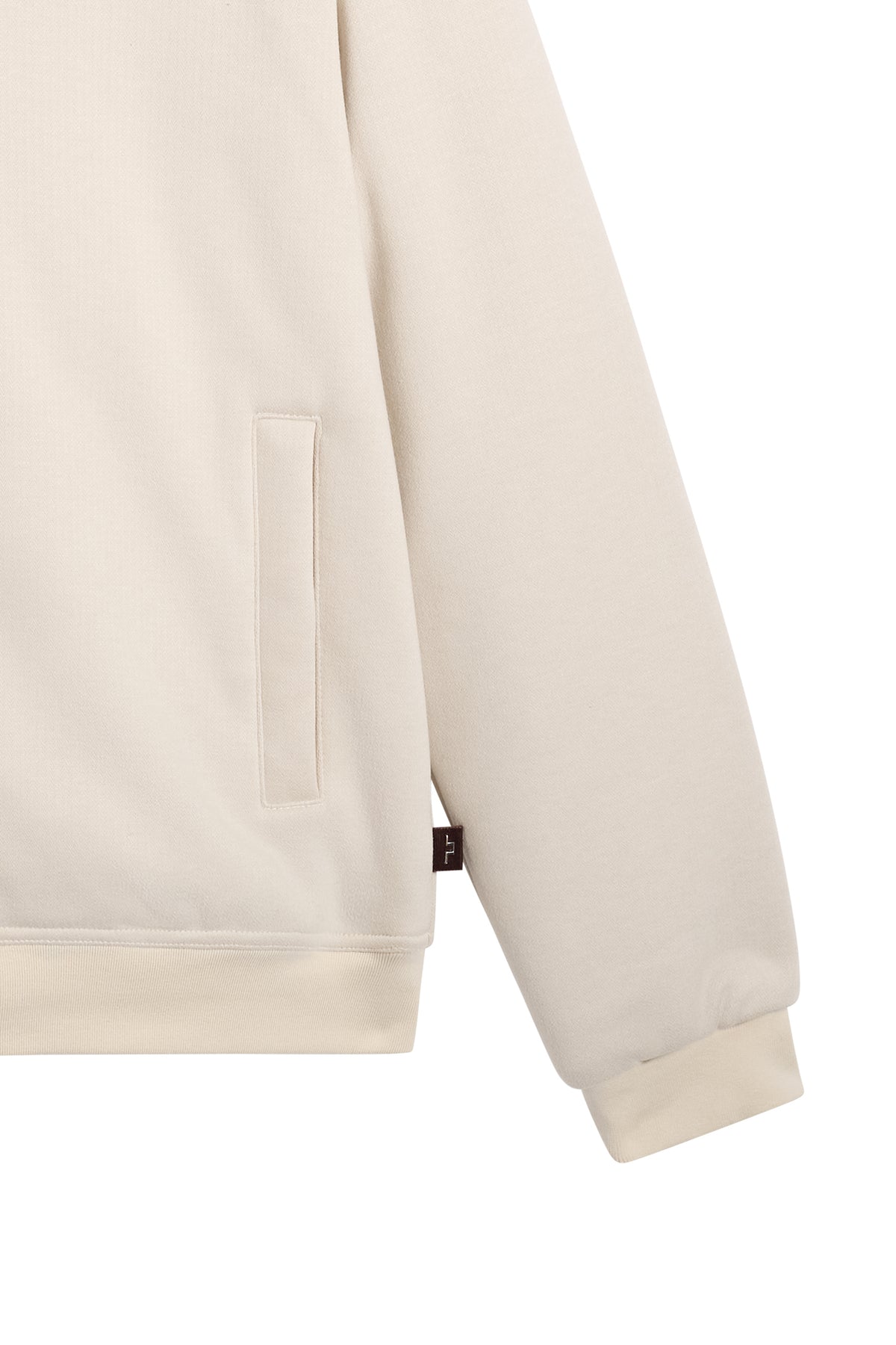 Close-up of the Henry Bonded Hoodie in Moonbeam, showing the side pocket, ribbed cuff, and logo tab.