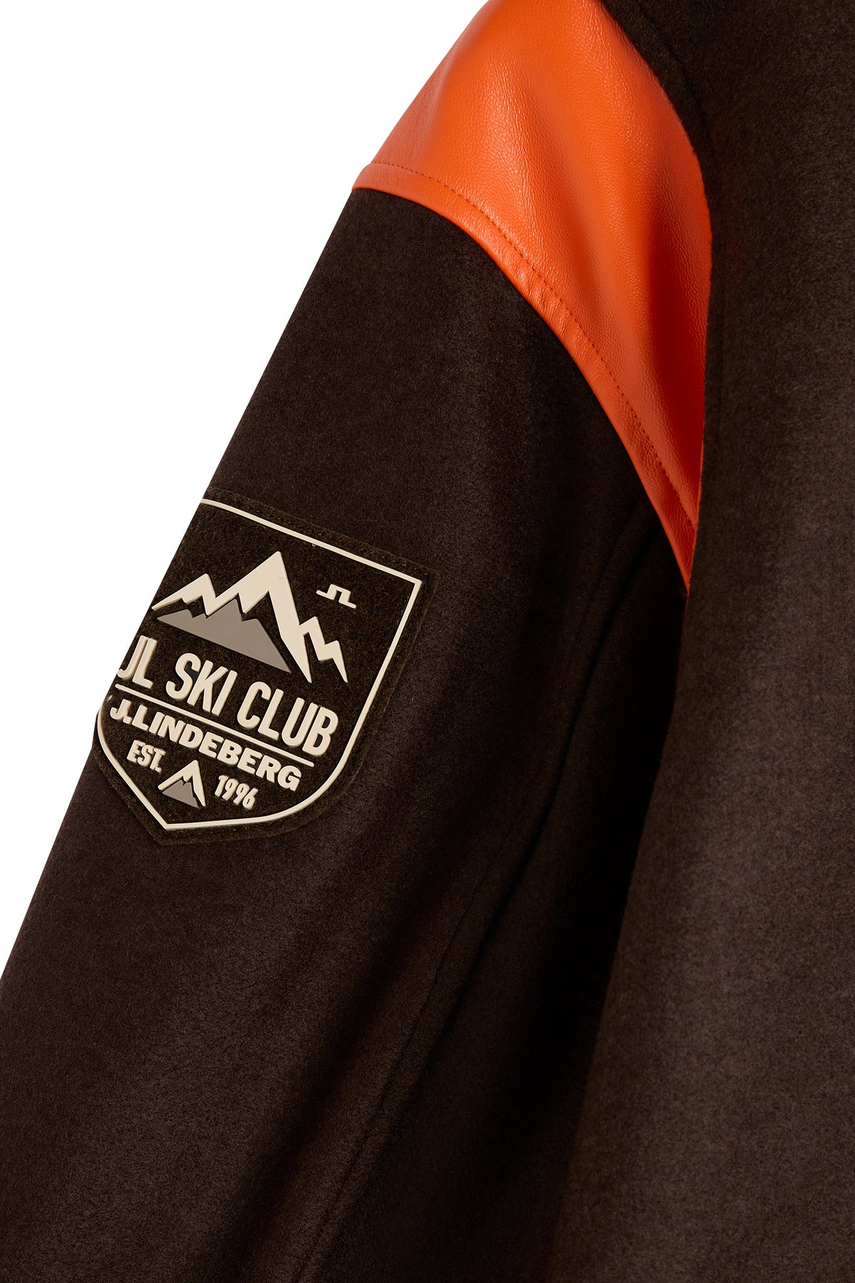 Close-up of the JL Ski Club sleeve patch on the Bobby Bomber Jacket in Seal Brown.