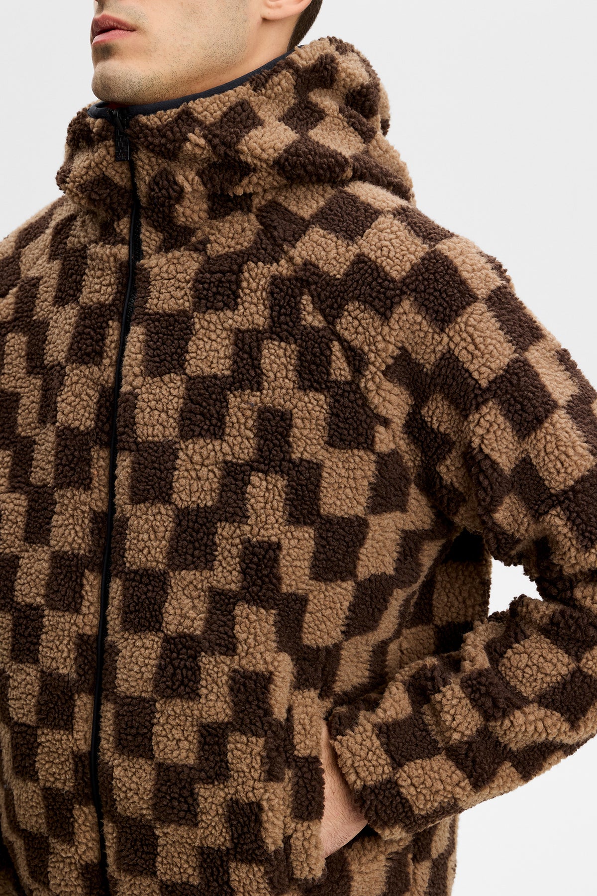 Close-up of the Rory Reversible Teddy Jacket in Golden Poppy, showing the checkered teddy fleece and hood.