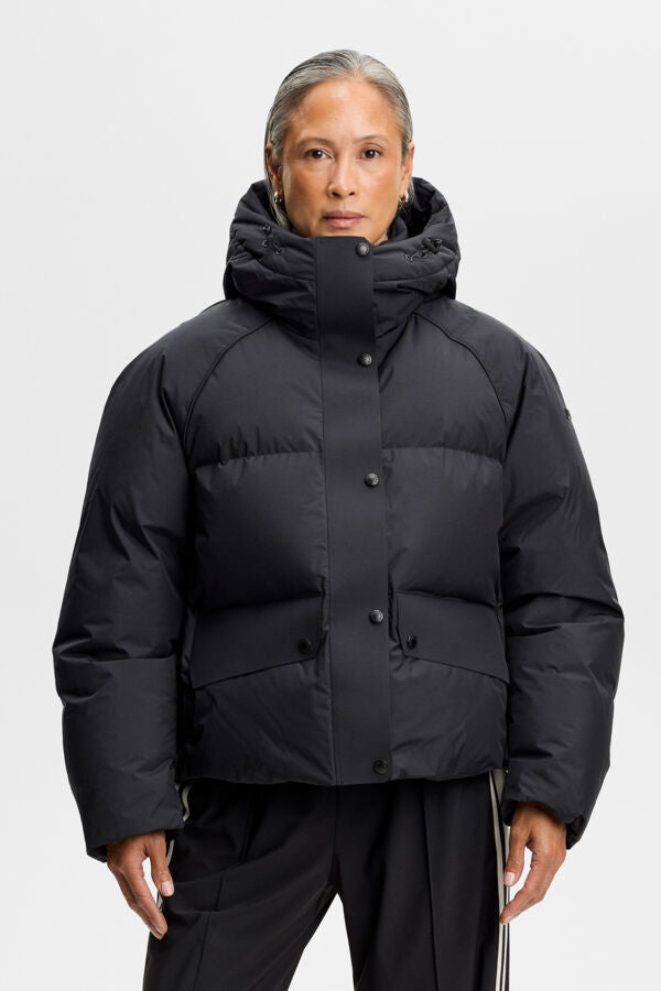 Lea Down Jacket in black, front view with hood, snap-button placket, and flap pockets.