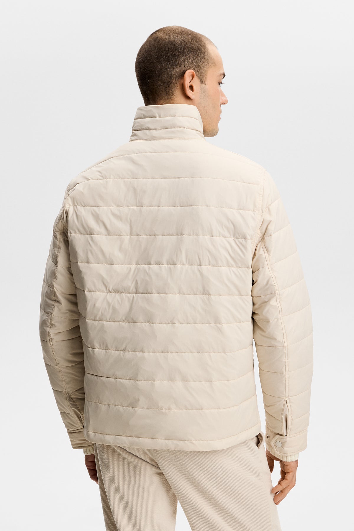 Back view: Bailey Light Padded Jacket in Moonbeam with horizontal quilting and a stand collar.