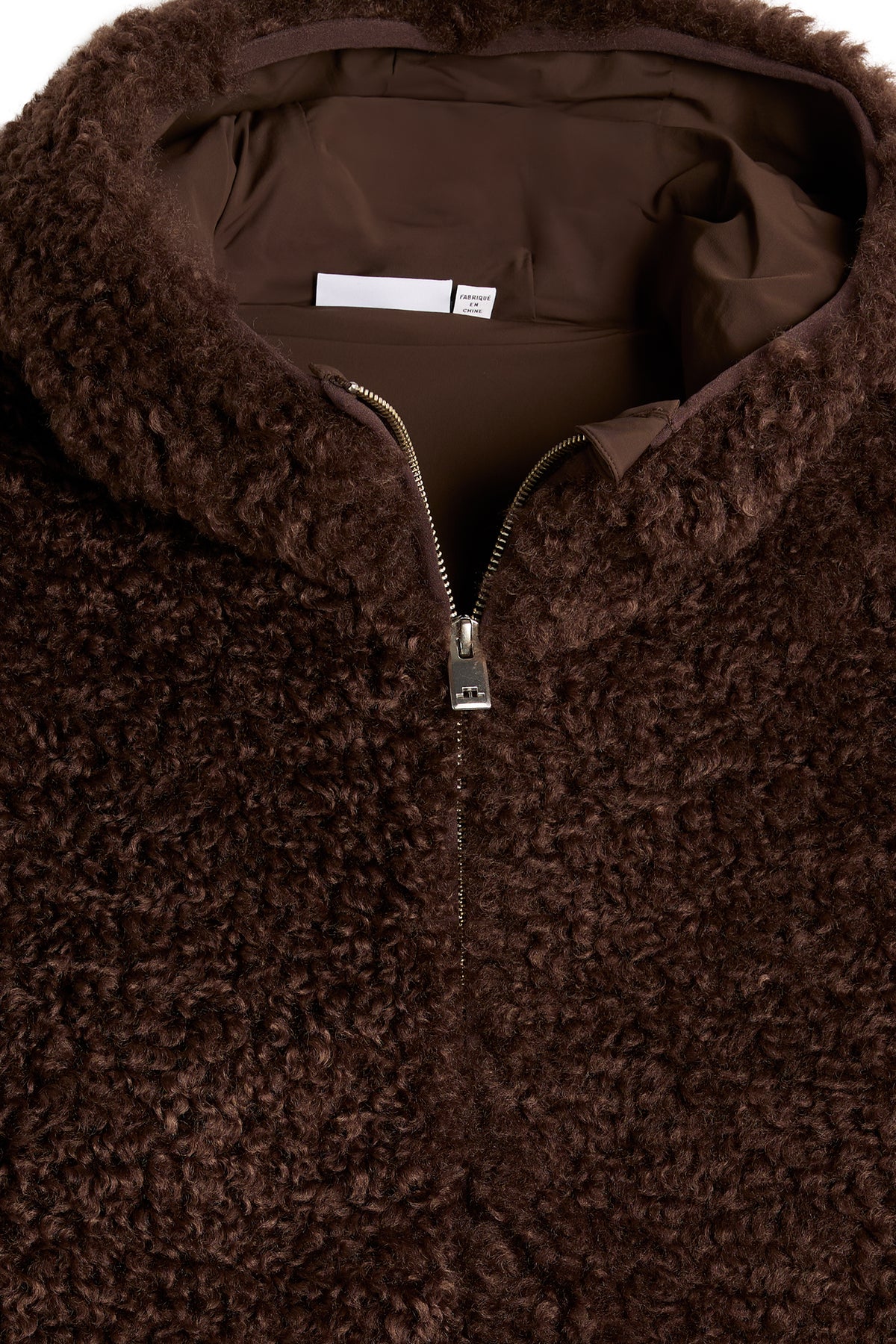 Close-up of the front zipper, lined hood, and textured pile fabric on the Elina Pile Jacket in Seal Brown.