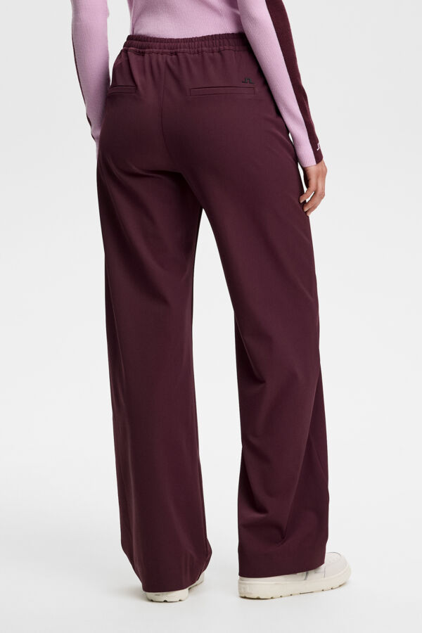 Back view: Anja Pant in Winetasting with elastic waistband, back welt pocket, and Bridge logo.