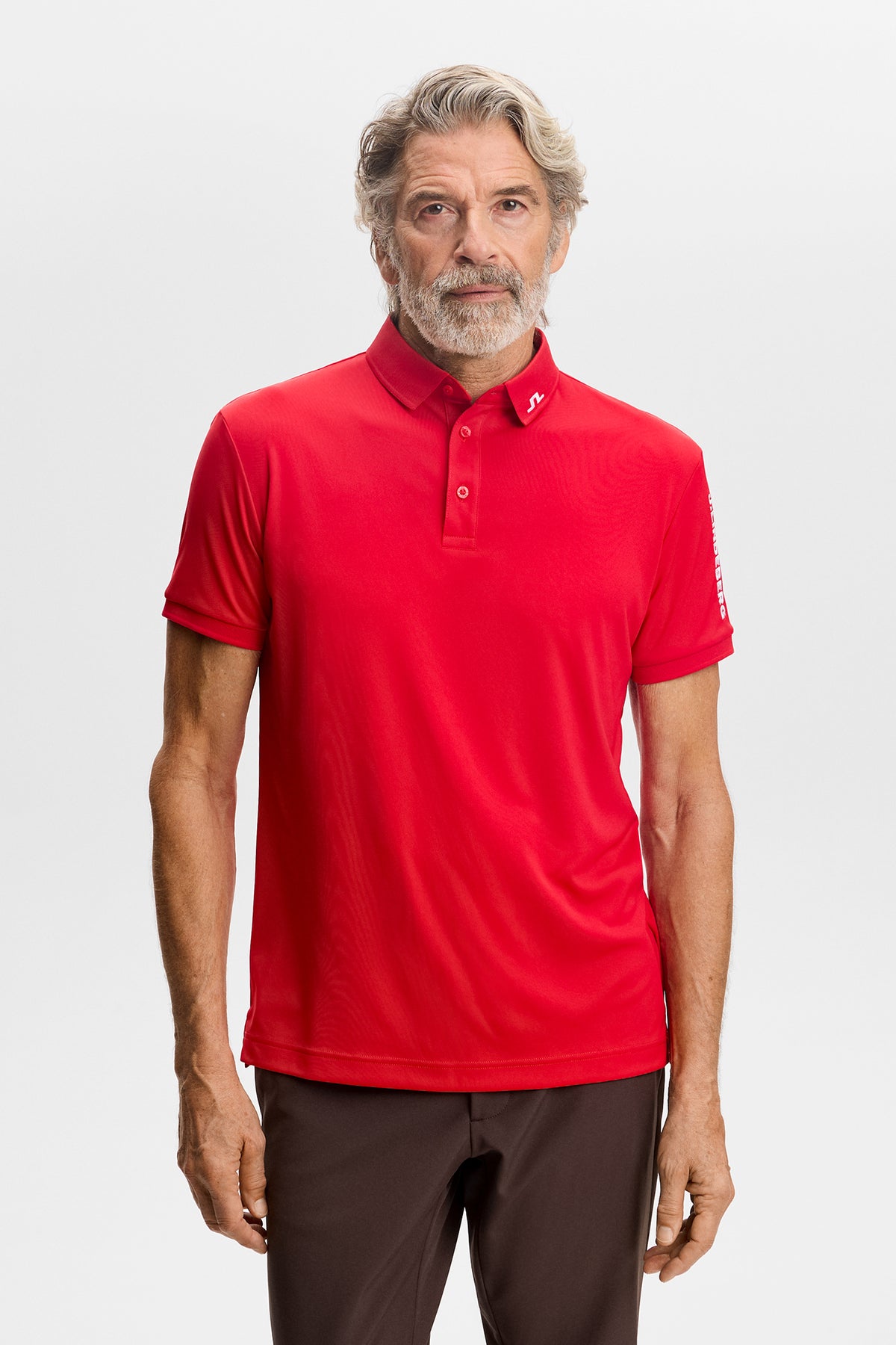 Front view: Red Tour Tech Polo with short sleeves, three-button placket, and Bridge logo on the collar.