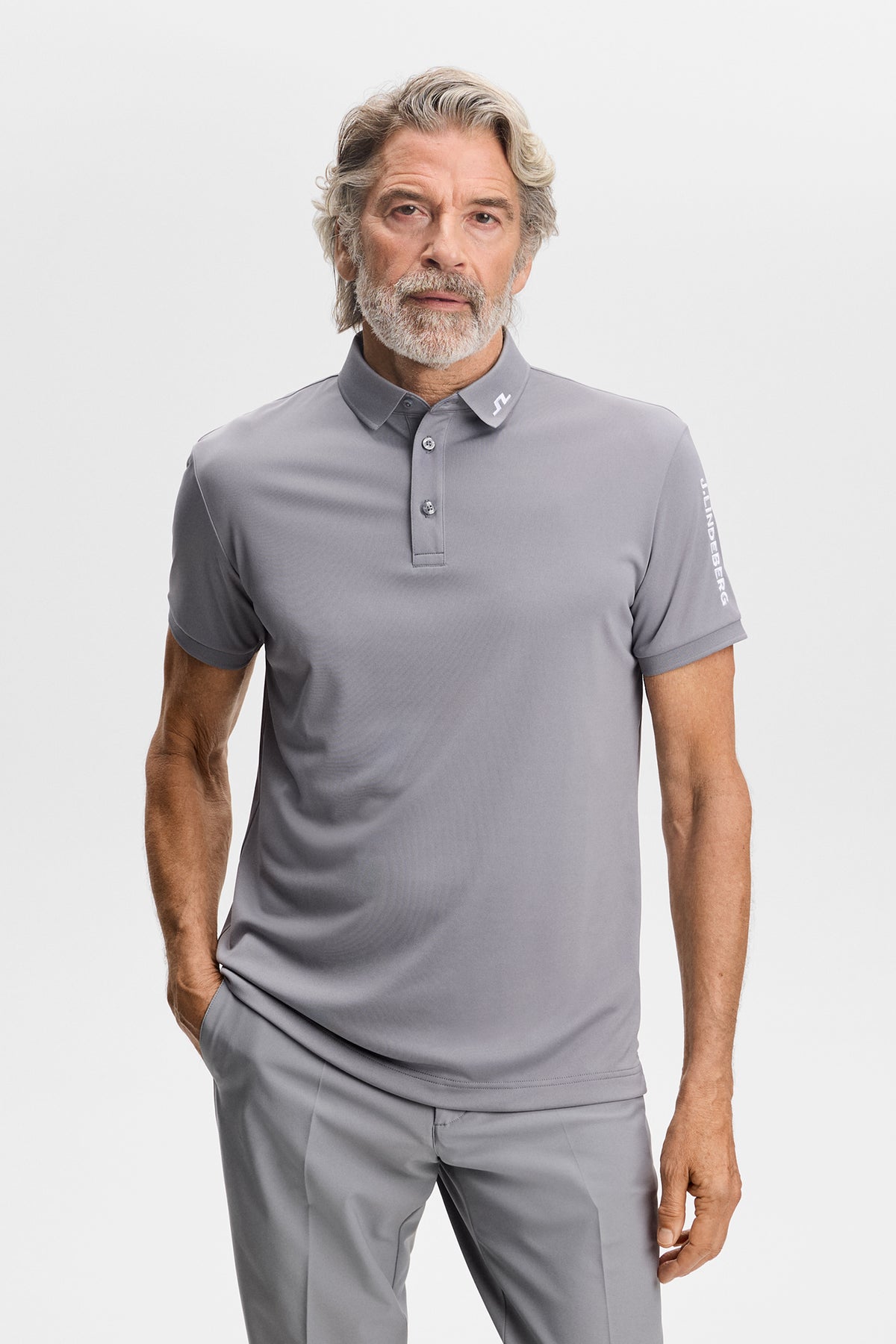 Front view of the Tour Tech Polo in gray with a three-button placket and Bridge logo on the collar.