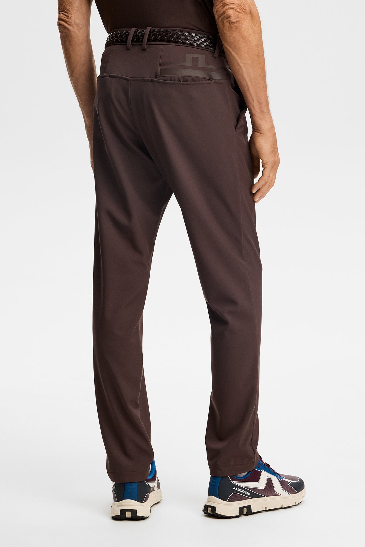 Back view of Mitch Bonded Players Pant in Seal Brown with back pockets and a tonal Bridge logo.