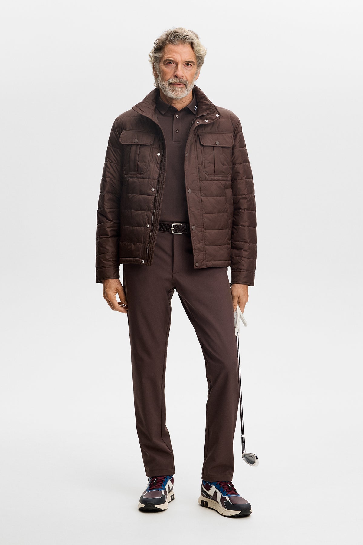 Model wearing the Mitch Bonded Players Pant in Seal Brown in a full-body studio setting.
