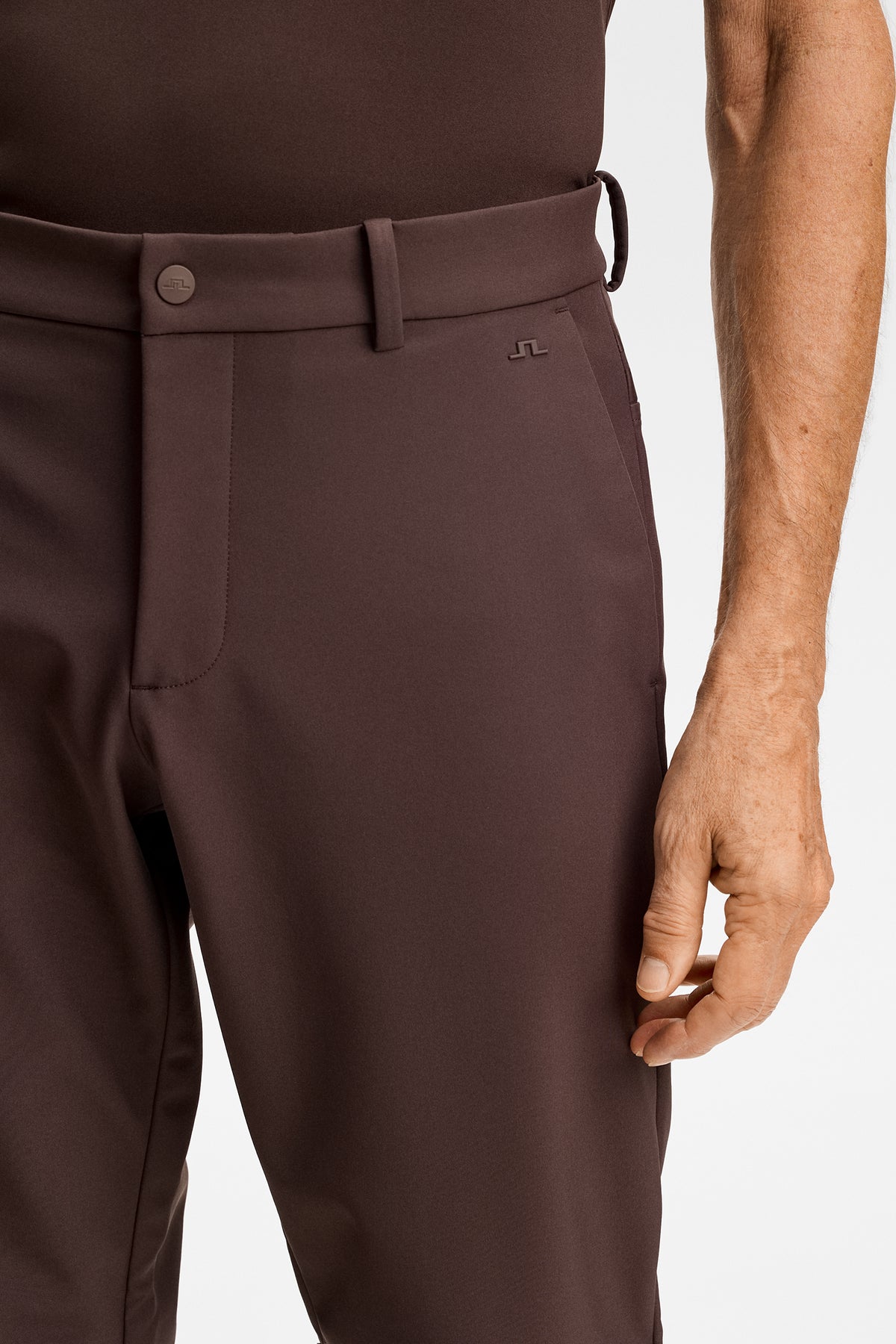 Close-up of the waistband, side pocket, and Bridge logo on the Mitch Bonded Players Pant in Seal Brown.
