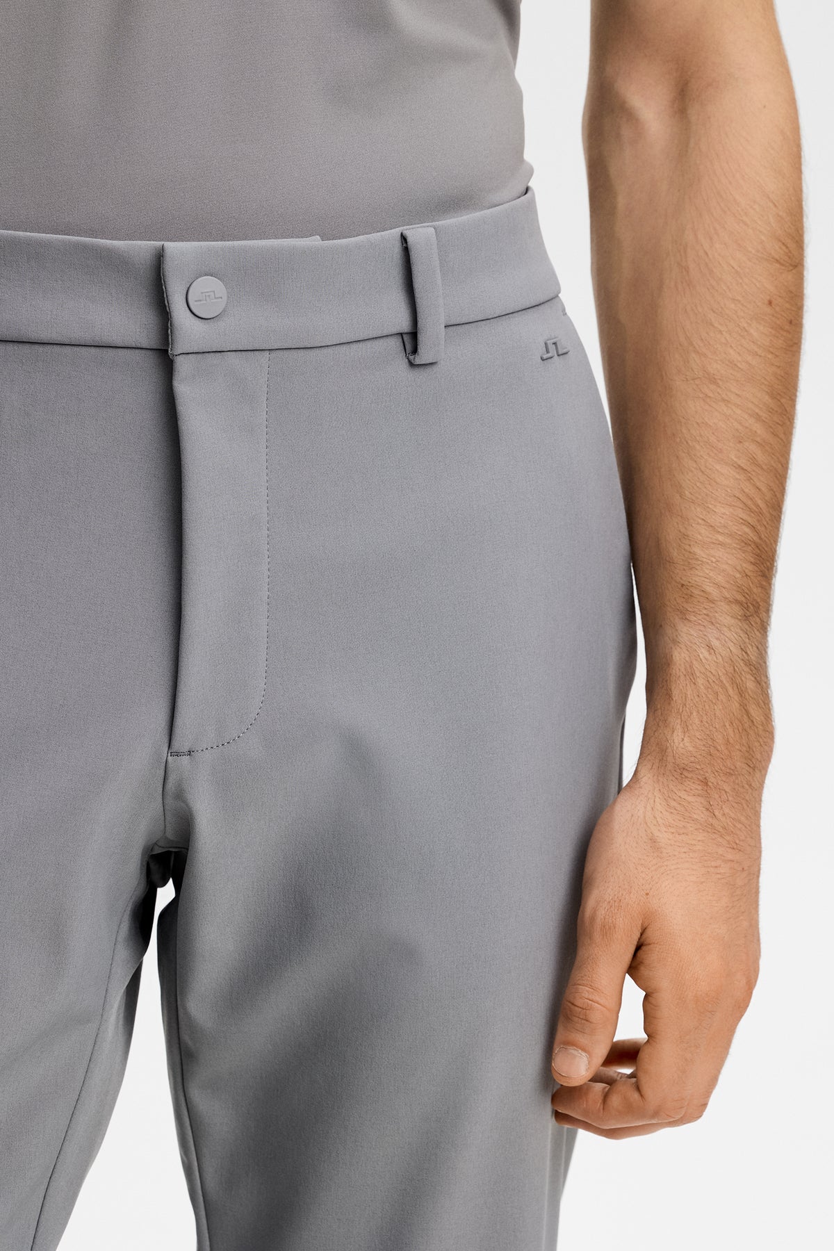 Close-up of the waistband, button closure, and Bridge logo on the Mitch Bonded Players Pant in Night Owl.