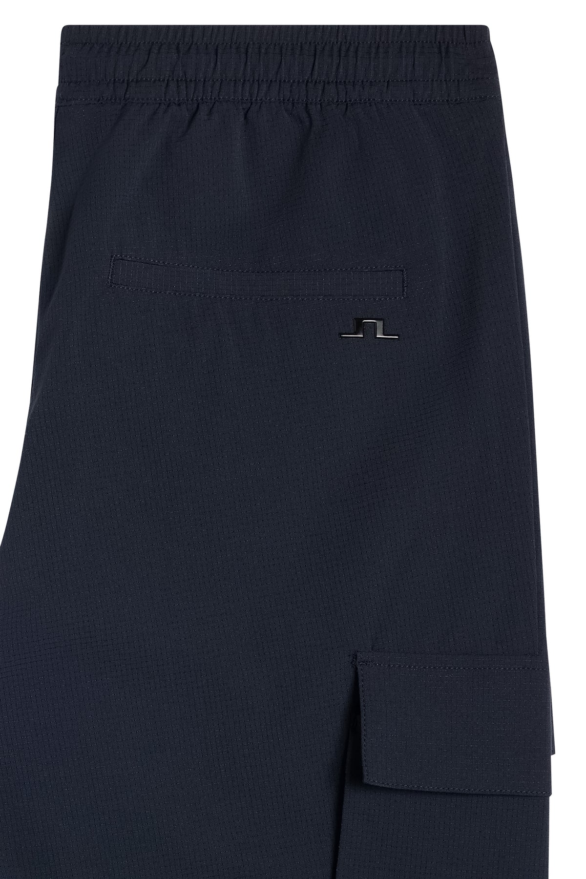 Close-up of the Harris Tech Pant in navy, showing the back pocket with Bridge logo and side cargo pocket.