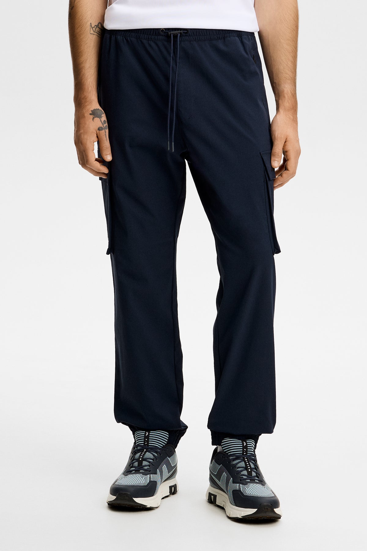 Harris Tech Pant in JL Navy, front view showing the elastic drawstring waist and side cargo pockets.