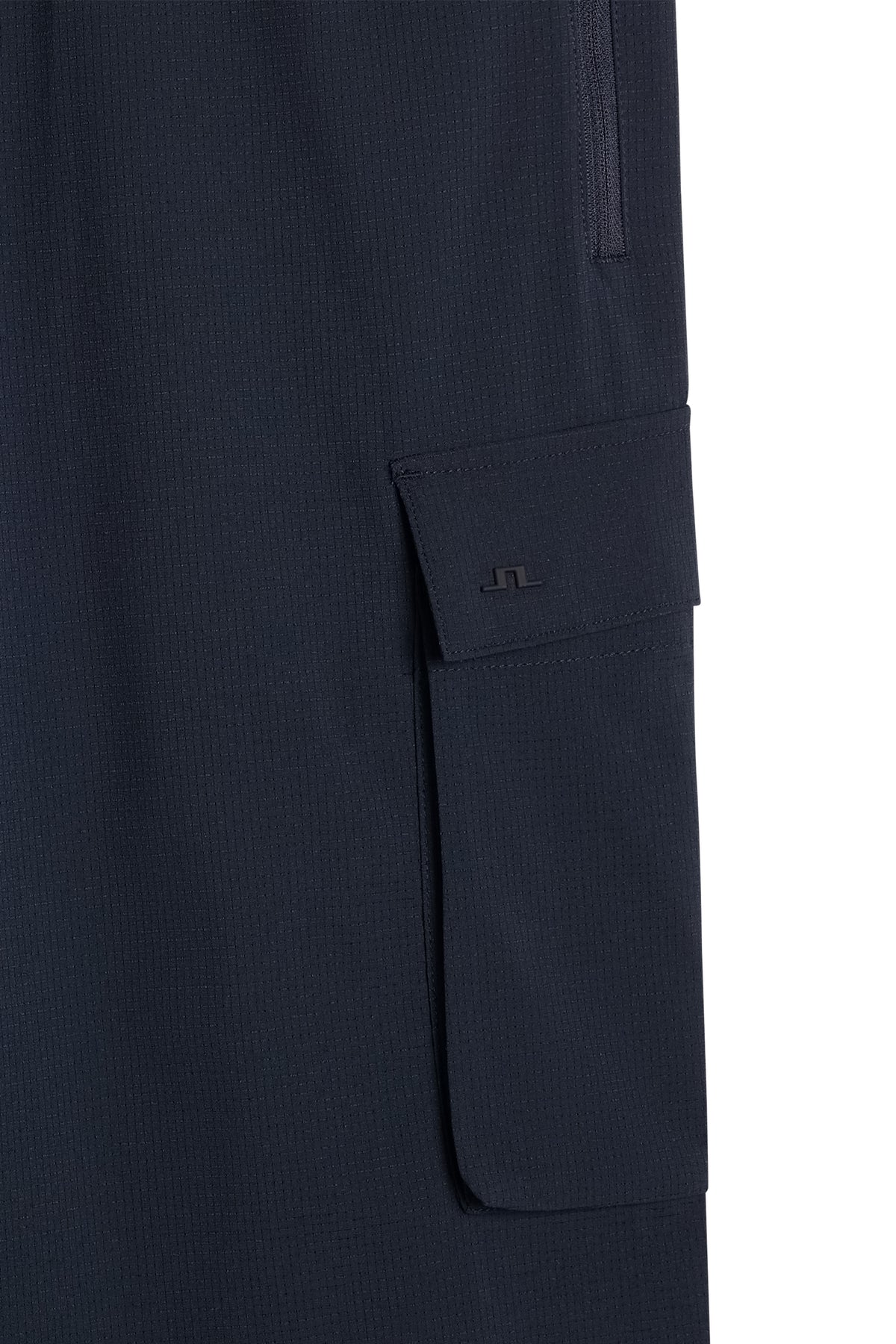 Close-up of the cargo pocket with tonal Bridge logo on the Harris Tech Pant in JL Navy.