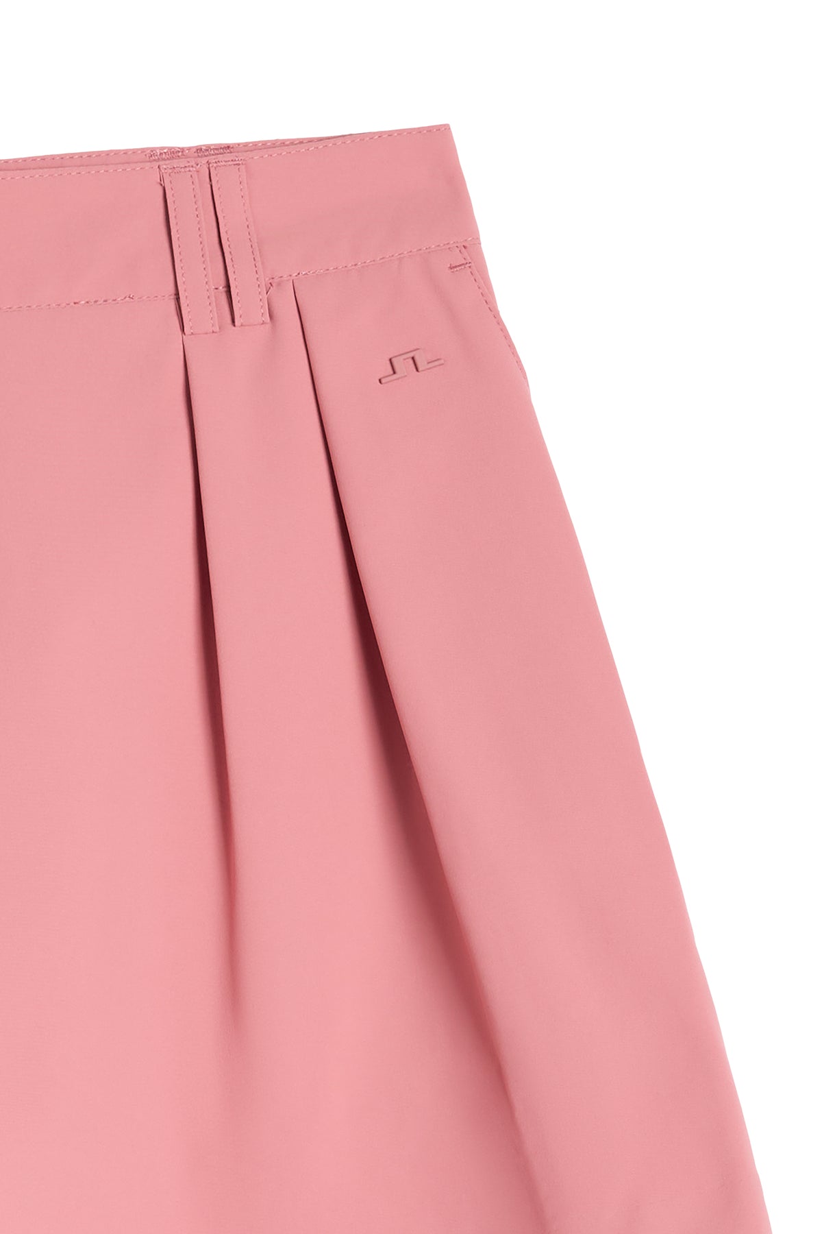 Close-up of front pleats, belt loops, and tonal Bridge logo on the Carmen Shorts in Dusty Rose.